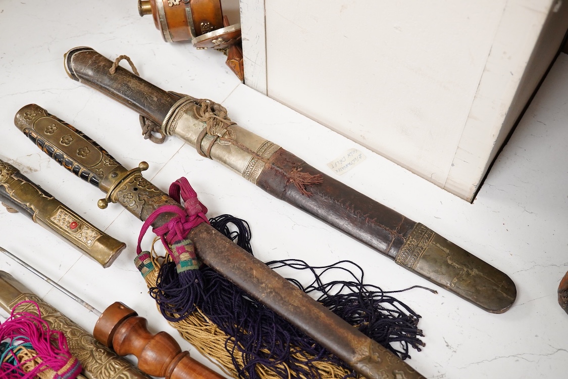 Four Tibetan daggers, early 20th century and a prayer wheel